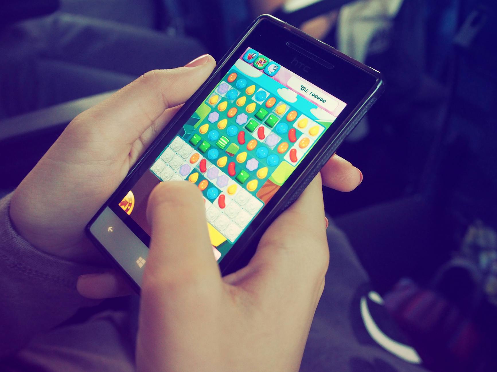 Hands holding smartphone playing a mobile sweepstakes casino game